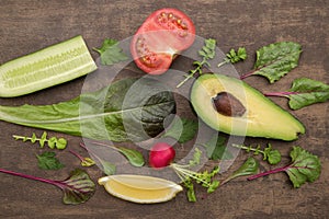 Organic vegetables and herbs on brown abstract background. Flat lay, top view