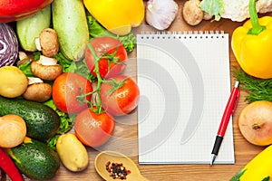 Organic Vegetables on Wooden Background and Notebook