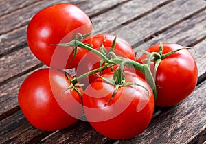 Organic Vine ripe tomatoes on wooden table