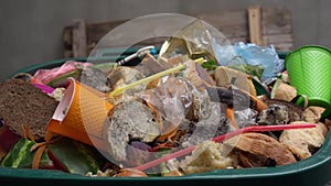 Organic waste, unsold food, uneaten bread, plastic in the trash can. The food throw out in household, home kitchen or in