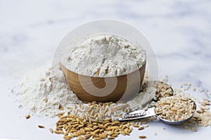 Organic white flour Thai in wooden bowl with white rice Thai and rice ears isolated on tone background, Food and baking ingredient