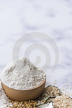 Organic white flour Thai in wooden bowl with white rice Thai and rice ears isolated on tone background, Food and baking ingredient