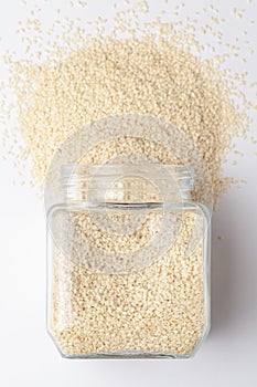 Organic White  Sesame seedsSesamum indicum polished or white Til without shell, spilled and in a glass jar. photo