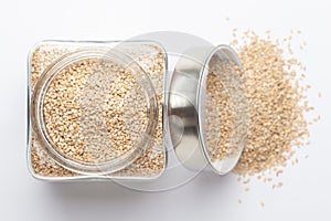 Organic White Sesame seedsSesamum indicum or white Til with shell in a glass jar with Lid, photo