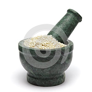 Organic White Sesame (Sesamum indicum) on marble pestle.