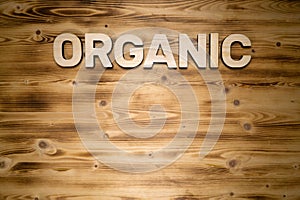ORGANIC word made of wooden block letters on wooden board