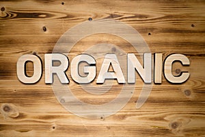 ORGANIC word made of wooden block letters on wooden board
