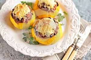 Organic yellow patissons stuffed with meat, onions, carrots, mushrooms and red pepper baked in the oven with cheese.