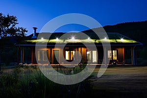 organicmodern house with green roof lit by downlights