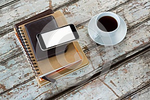 Organiser with mobile phone and coffee