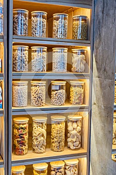 Organization in the kitchen. Italian pasta in glass jars on the shelf