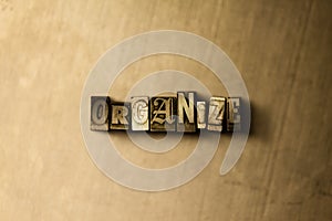 ORGANIZE - close-up of grungy vintage typeset word on metal backdrop