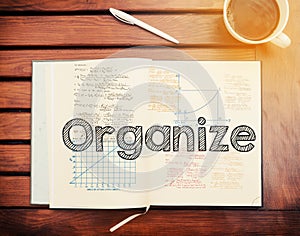 Organize : text inside notebook on table with coffee