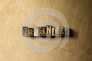 ORGANIZED - close-up of grungy vintage typeset word on metal backdrop