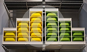Organized Color Coordinated Storage Bins on a Shelf
