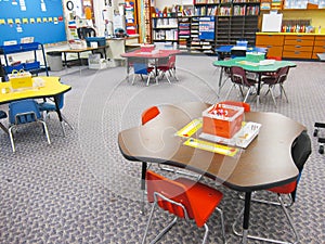 Organized kindergarten classroom with tables and chairs