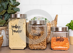 Organized kitchen pantry with labeled glass canisters