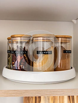 Organized labeled food pantry in a home kitchen with spices