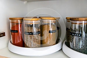 Organized labeled food pantry in a home kitchen with spices