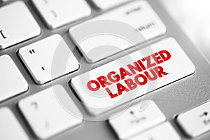 Organized Labour - workers joined through membership of trade unions, text concept button on keyboard