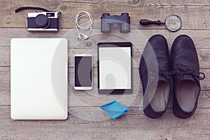 Organized modern and retro objects on wooden table. Adventure essentials for man