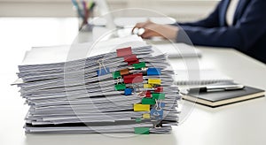 Organized stack of documents with colorful binder clips
