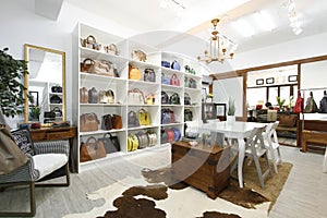 Organized and well-lighted bag store with various types of leather bags on display