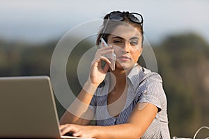 Organized woman, laptop and phone outdoors