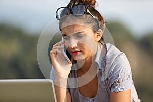 Organized woman, laptop and phone outdoors