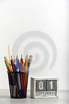 Organizer with pencils and ruler, stationery stand and wooden calendar with date September 01.