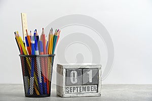 Organizer with pencils and ruler, stationery stand and wooden calendar with date September 01.