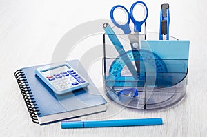 Organizer with stationery tools, notepad, calculator and pen on