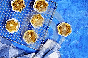 Oriental Algerian sweet cookies named dziriettes on knidlette in Arabic language on grill