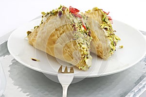 Oriental Arabic sweet warbat with qishta, kadayif, kunafa, with pistachio and cheese photo