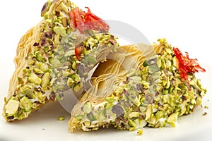 Oriental Arabic sweet warbat with qishta, kadayif, kunafa, with pistachio and cheese