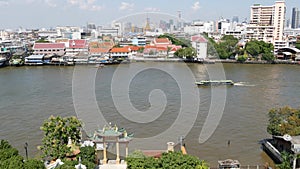 Oriental boat floating on river in Krungthep city. Modern transport vessel floating on calm Chao Praya river on sunny day in