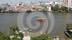 Oriental boat floating on river in Krungthep city. Modern transport vessel floating on calm Chao Praya river on sunny day in