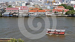 Oriental boat floating on river in Krungthep city. Modern transport vessel floating on calm Chao Praya river on sunny day in
