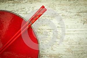 Oriental ceramic plate and chopsticks in red
