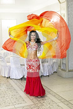 Oriental dancer in a red-yellow dress.