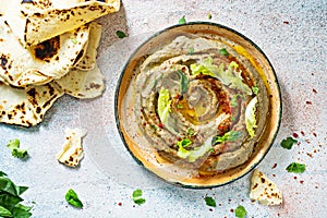An oriental dish of baked eggplant babaganush eggplant puree with spices, herbs, lettuce and oriental flatbreads