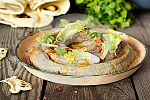An oriental dish of baked eggplant babaganush eggplant puree with spices, herbs, lettuce and oriental flatbreads