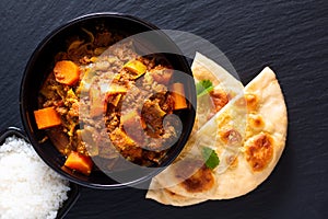 Oriental food concept spicy grounded or minced beefs masala curry with naan bread and rice
