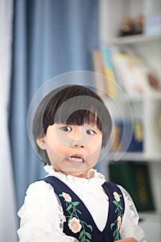 Oriental four-year-old girl making faces