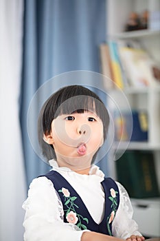 Oriental four-year-old girl making faces