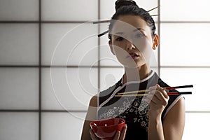 Oriental girl with chopstick photo