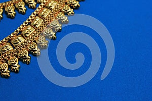 Oriental jewelry isolated on a blue background. with the image of a heart a symbol of love. Valentine`s day gift