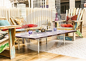 Oriental lounge set up in a lebanese restaurant with wooden chairs and silk cushions