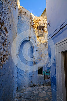 Oriental narrow street with blue houses in Medina, Hammamet Tunisia