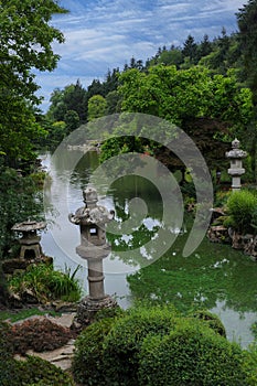 Oriental park with wunderful trees and stone lamps